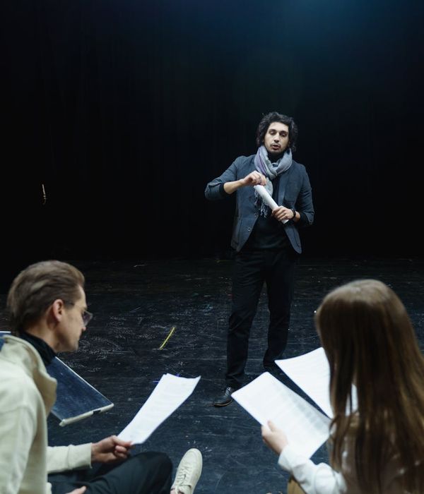 Man performing a functional strength exercise in a dark room with blue light accents.